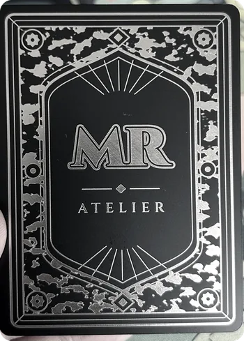 The MR Atelier card back, engraved in steel
